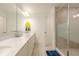 Bright bathroom featuring a long vanity with double sinks and a glass-enclosed shower at 1868 Sanibel Dr, Davenport, FL 33896