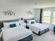 Comfortable bedroom featuring two beds with white linens and decorative wall art at 1868 Sanibel Dr, Davenport, FL 33896