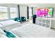 Bright bedroom with two beds, a TV, and large windows overlooking a serene view at 1868 Sanibel Dr, Davenport, FL 33896