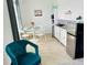 Cozy dining area featuring a modern round table, white chairs, and a convenient kitchenette at 1868 Sanibel Dr, Davenport, FL 33896
