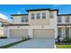 Inviting townhome exterior with a two-car garage and manicured landscaping at 1868 Sanibel Dr, Davenport, FL 33896