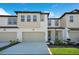 Charming townhome featuring a two-car garage and modern architectural details at 1868 Sanibel Dr, Davenport, FL 33896