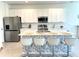 Bright kitchen featuring a large island with seating, stainless steel appliances, and white cabinetry at 1868 Sanibel Dr, Davenport, FL 33896