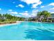 Resort-style swimming pool with palm trees and lounge chairs at 1868 Sanibel Dr, Davenport, FL 33896