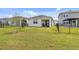 Fenced backyard with a covered patio and green lawn at 1872 Summer Serenity Dr, Kissimmee, FL 34744