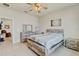 Bright bedroom featuring a rustic wood bed frame and dresser set with ceiling fan at 1872 Summer Serenity Dr, Kissimmee, FL 34744