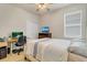 Comfortable bedroom with a ceiling fan and window at 1872 Summer Serenity Dr, Kissimmee, FL 34744