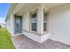 Inviting front entrance featuring a stylish blue door and brick paved porch at 1872 Summer Serenity Dr, Kissimmee, FL 34744