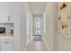 Bright hallway leading to a front door featuring a white framed glass insert and side windows at 1872 Summer Serenity Dr, Kissimmee, FL 34744