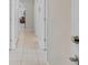 Hallway with tile floors and white walls, leading to the various rooms of the home at 1872 Summer Serenity Dr, Kissimmee, FL 34744