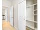 Hallway with tile floors, access to multiple rooms, and a closet with built-in shelving at 1872 Summer Serenity Dr, Kissimmee, FL 34744