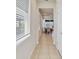 Bright hallway with natural light, leading into a dining area and offering a glimpse of the backyard at 1872 Summer Serenity Dr, Kissimmee, FL 34744