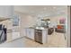 Modern kitchen with stainless steel appliances, white cabinets, tile flooring, and an island sink at 1872 Summer Serenity Dr, Kissimmee, FL 34744