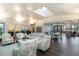 Bright lounge area with stylish furniture, artwork, and a skylight creating an inviting and comfortable space at 1872 Summer Serenity Dr, Kissimmee, FL 34744