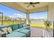 Covered outdoor patio with comfortable seating and a view of the lake at 1872 Summer Serenity Dr, Kissimmee, FL 34744