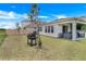 Enjoy outdoor living in this backyard with a grilling area and a covered patio for relaxation at 18863 Rawson St, Orlando, FL 32827