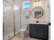 Modern bathroom featuring glass shower, updated vanity, round mirror, and natural light at 18863 Rawson St, Orlando, FL 32827