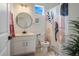 Stylish bathroom featuring a vanity with round mirror and a shower with a tub, designed with modern fixtures at 18863 Rawson St, Orlando, FL 32827