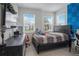 Well-lit bedroom with neutral walls, tiled floors, and a comfortable bed, offering a serene and inviting space at 18863 Rawson St, Orlando, FL 32827