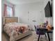 Cozy bedroom featuring a comfortable bed, side table, and a dedicated workspace with ample lighting for studying at 18863 Rawson St, Orlando, FL 32827