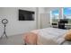 Bright bedroom with large windows, a comfortable bed, and a dedicated workspace at 18863 Rawson St, Orlando, FL 32827