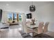 Open dining and living area with modern lighting, large windows, and a view of the outdoors at 18863 Rawson St, Orlando, FL 32827