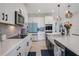 Bright kitchen with white cabinets, quartz countertops, stainless steel appliances, and a farmhouse sink at 18863 Rawson St, Orlando, FL 32827
