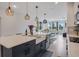 Modern kitchen featuring a large island with a white countertop and stainless steel appliances, perfect for culinary enthusiasts at 18863 Rawson St, Orlando, FL 32827