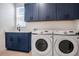 Functional laundry room with washer, dryer, sink, and storage cabinets, designed for convenience and organization at 18863 Rawson St, Orlando, FL 32827