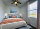 Inviting bedroom with soft lighting, comfortable bed, and picturesque window view at 195 Preston Ave, Davenport, FL 33837