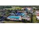 Resort-style community pool and tennis courts, surrounded by lush landscaping and beautiful buildings at 195 Preston Ave, Davenport, FL 33837