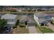 Well-manicured lawn and brick driveway leading up to the attached two-car garage at 195 Preston Ave, Davenport, FL 33837