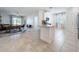 Open-concept kitchen with white cabinetry, stainless steel appliances, and seamless flow to the dining area at 195 Preston Ave, Davenport, FL 33837