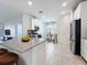 Well-lit kitchen boasts stainless steel appliances, white cabinets, and a cozy breakfast nook at 195 Preston Ave, Davenport, FL 33837