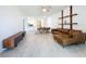 Bright living room featuring an open floor plan, stylish shelving, and a comfortable leather couch at 195 Preston Ave, Davenport, FL 33837