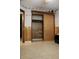 Bedroom with wood paneled walls, a tiled floor, and closet doors at 206 Willow St, Lake Wales, FL 33859