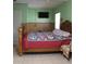 Cozy bedroom featuring a comfortable bed, tv and a window for natural light at 206 Willow St, Lake Wales, FL 33859