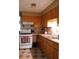 Cozy kitchen with warm wood cabinetry, an oven, and a convenient double sink at 206 Willow St, Lake Wales, FL 33859