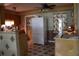 Efficient kitchen featuring wood cabinets, a white refrigerator, and a patterned tile floor at 206 Willow St, Lake Wales, FL 33859