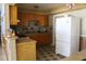 Well-lit kitchen with wood cabinets, tiled backsplash, and modern appliances at 206 Willow St, Lake Wales, FL 33859
