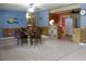 Open-concept living space with tile flooring, a dining area, and access to the kitchen at 206 Willow St, Lake Wales, FL 33859