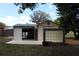 Outbuilding with metal roof, open garage door, and block glass window at 206 Willow St, Lake Wales, FL 33859