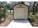 Outbuilding featuring metal siding, concrete pad and lockable door at 206 Willow St, Lake Wales, FL 33859
