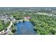 Aerial view of lakefront community surrounded by mature trees and nature at 219 Breezy Oaks Ct, Davenport, FL 33896