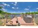 Wooden deck overlooking a serene lake, furnished with chairs and a storage box at 219 Breezy Oaks Ct, Davenport, FL 33896