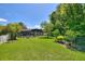 Expansive backyard with lush green lawn and screened pool, perfect for outdoor enjoyment and relaxation at 219 Breezy Oaks Ct, Davenport, FL 33896