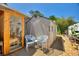 Well-kept backyard with sauna, storage shed, sitting area and gravel path surrounded by lovely plantings at 219 Breezy Oaks Ct, Davenport, FL 33896