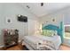 Well-lit bedroom with closet, TV, decor, and ceiling fan at 219 Breezy Oaks Ct, Davenport, FL 33896
