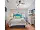 Bright bedroom features a bed, closet, decor, and ceiling fan at 219 Breezy Oaks Ct, Davenport, FL 33896