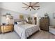 Bright bedroom with ceiling fan, neutral tones, and hardwood floors at 219 Breezy Oaks Ct, Davenport, FL 33896